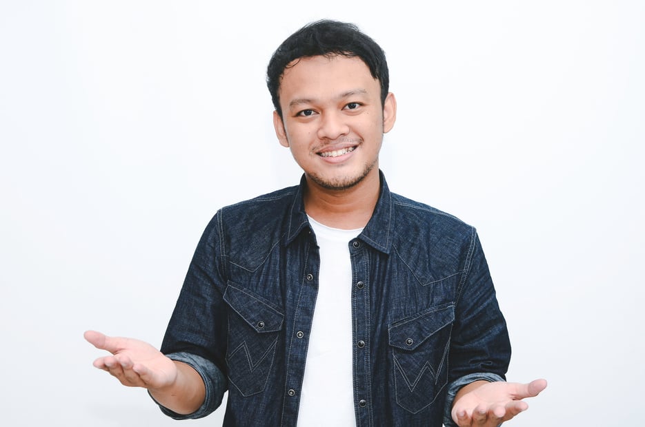 Young Asian Man Wearing Give Greeting Hands. Indonesian Man on Grey Background.